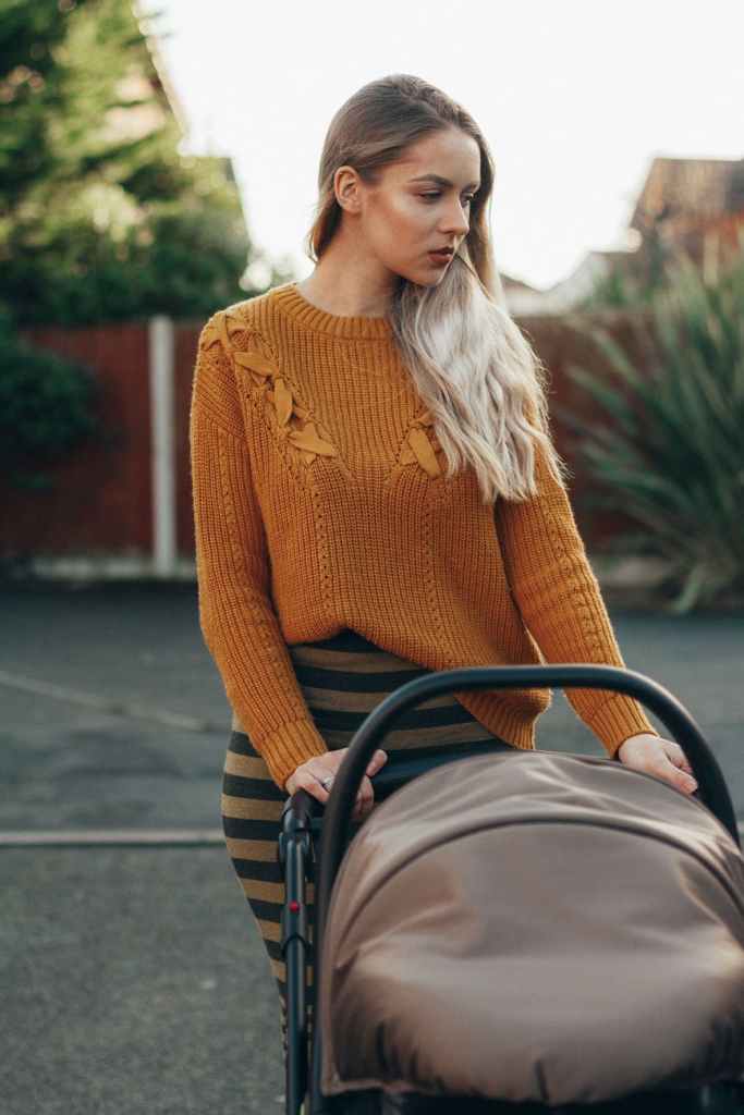 Unhappy woman pushes stroller